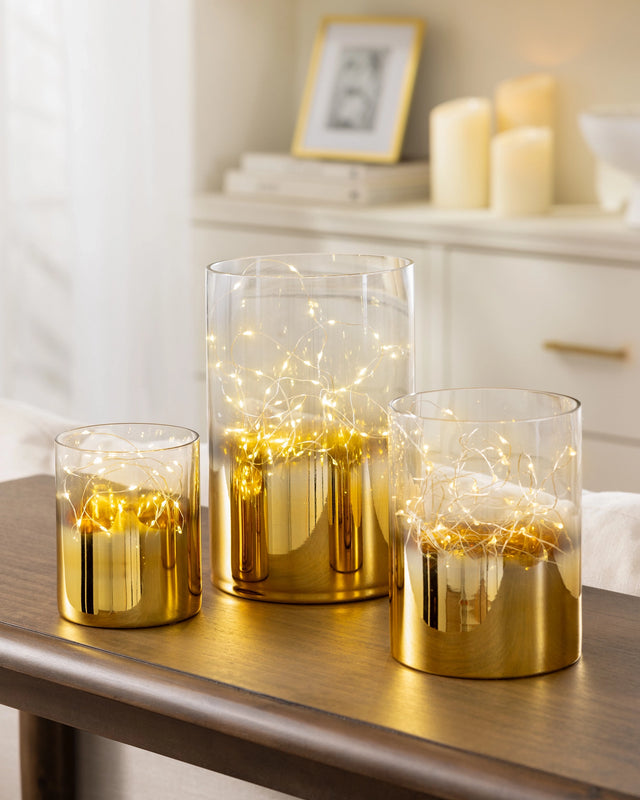 Balsam Hill Gold Ombre Fairy Light Hurricanes Set of 3 Displayed on a Table